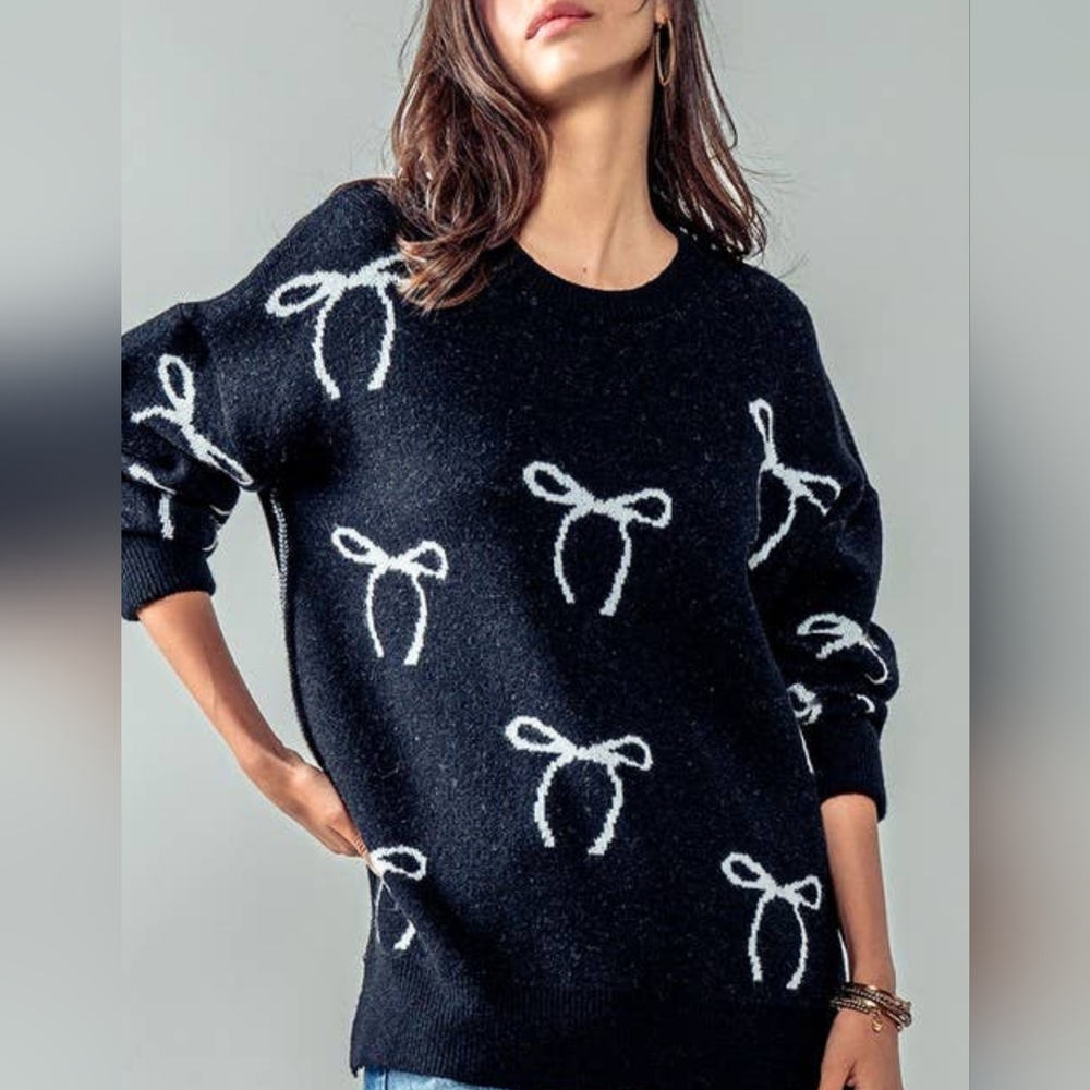 Black sweater with white bow design
